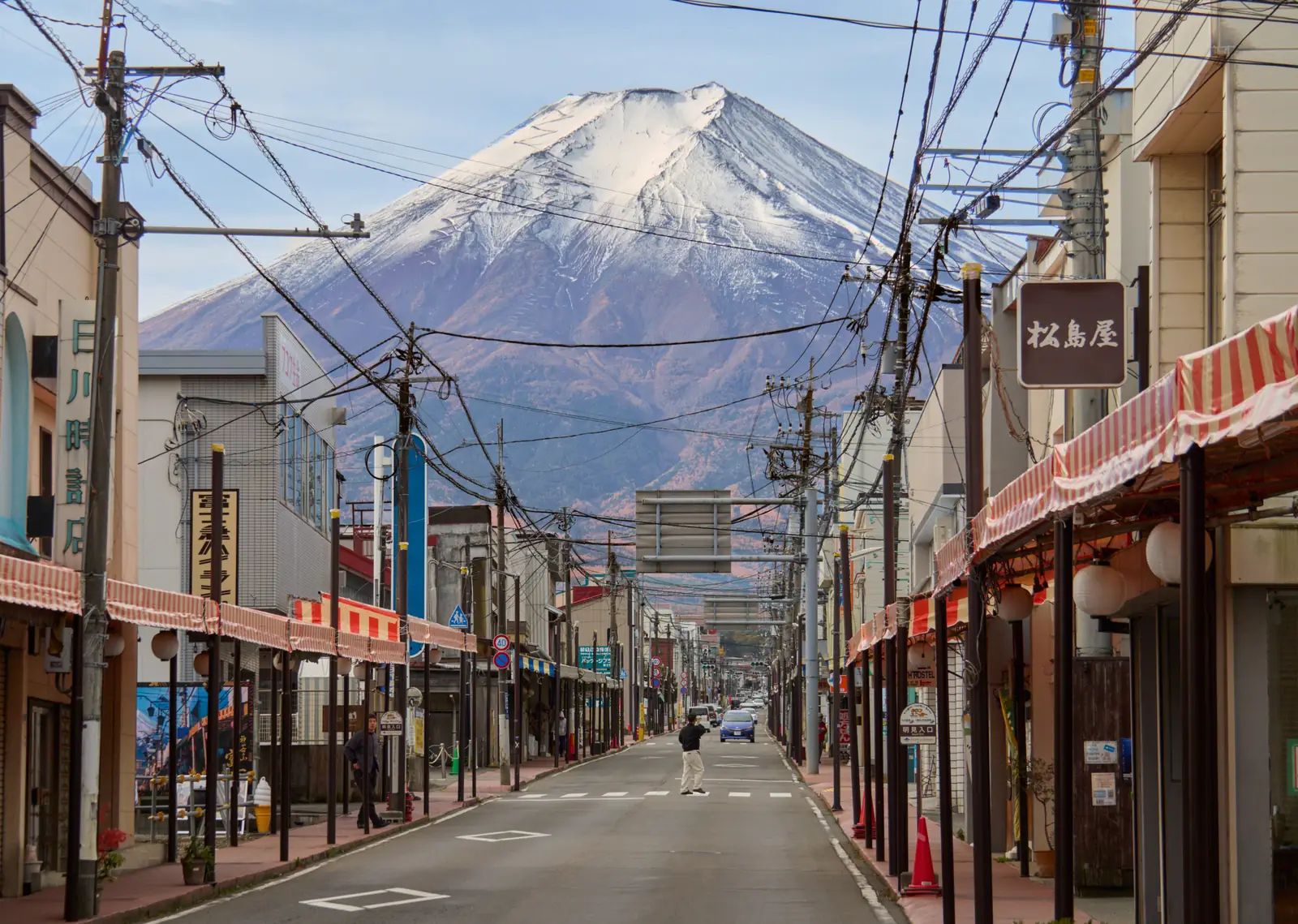 A shopping street in Fujiyoshida with snow-capped Mt Fuji at the end of the road