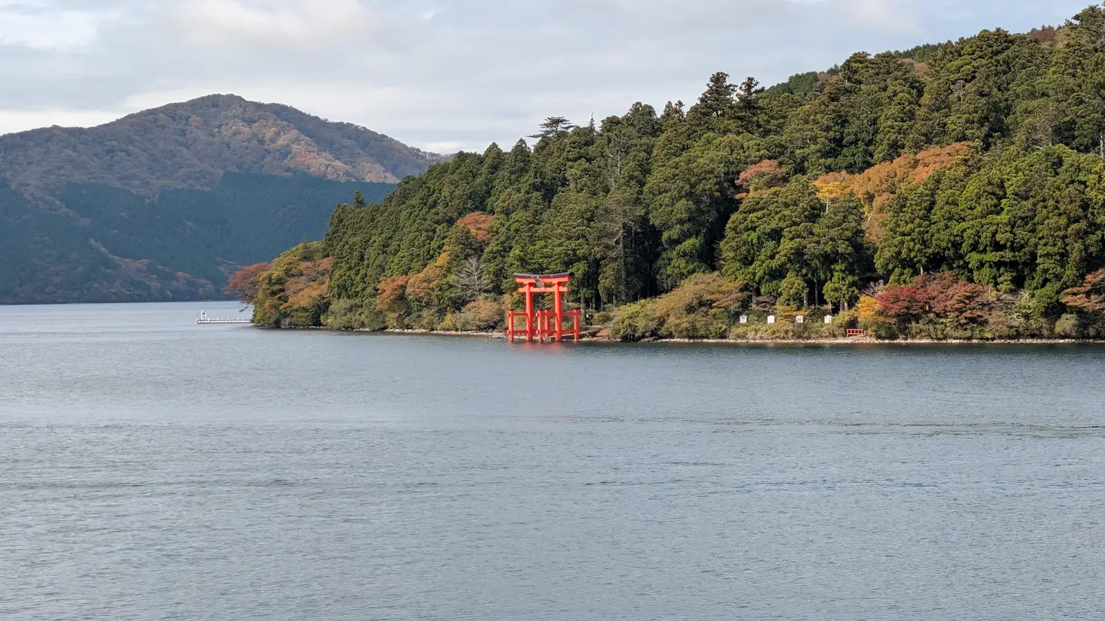 Lake Ashi in Hakone with the red Peace Torii of Hakone Shrine standing at the water's edge